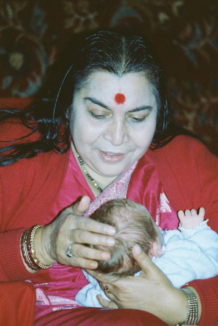Shri Maaji blessing a newborn baby